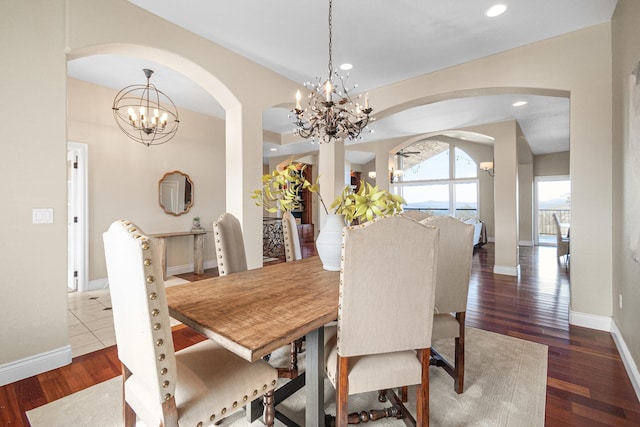 dining space featuring recessed lighting, wood finished floors, an inviting chandelier, and baseboards