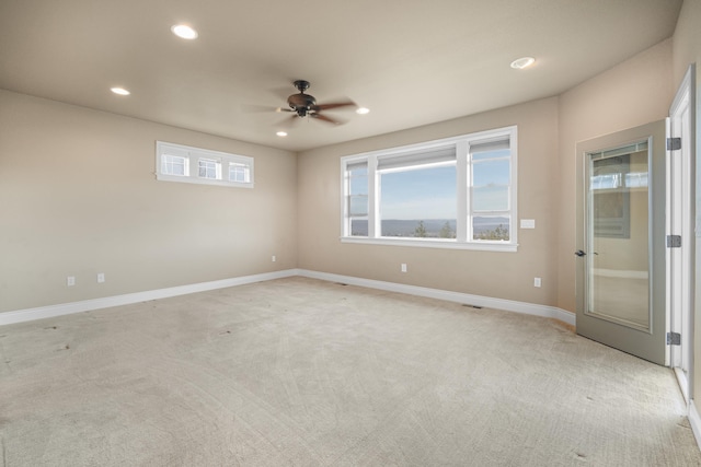 spare room with baseboards, ceiling fan, light colored carpet, and recessed lighting