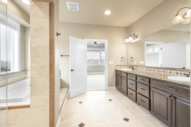 bathroom featuring tile patterned floors, a sink, and a healthy amount of sunlight