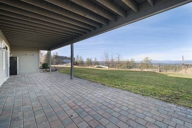 view of patio featuring fence and a mountain view