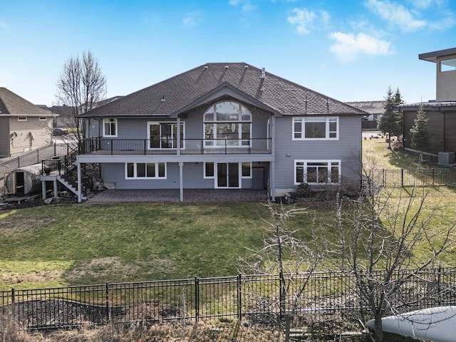 rear view of property with cooling unit, a patio, a fenced backyard, a lawn, and stairway
