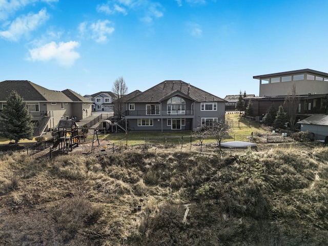 rear view of property with fence