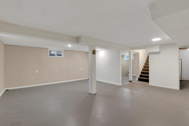 finished basement with stairs, baseboards, and recessed lighting