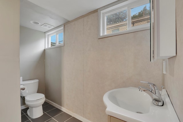 bathroom featuring visible vents, toilet, vanity, tile patterned flooring, and baseboards