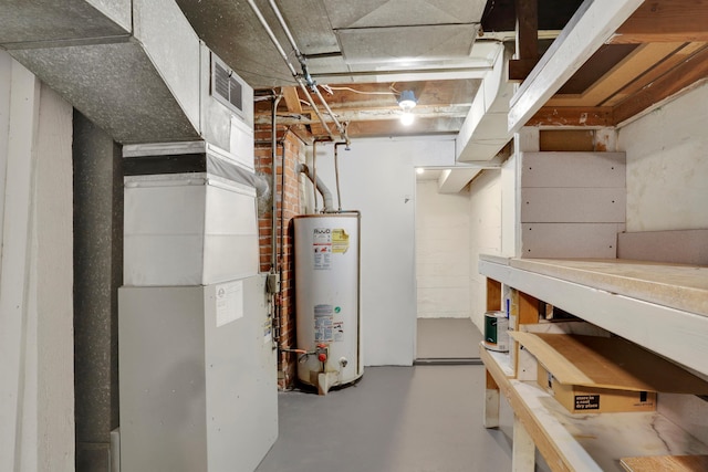 unfinished basement featuring gas water heater, visible vents, and heating unit