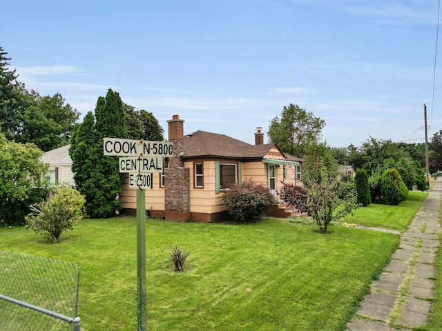 view of property exterior with a chimney and a yard