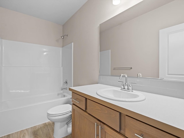 full bathroom with vanity, bathing tub / shower combination, wood finished floors, and toilet