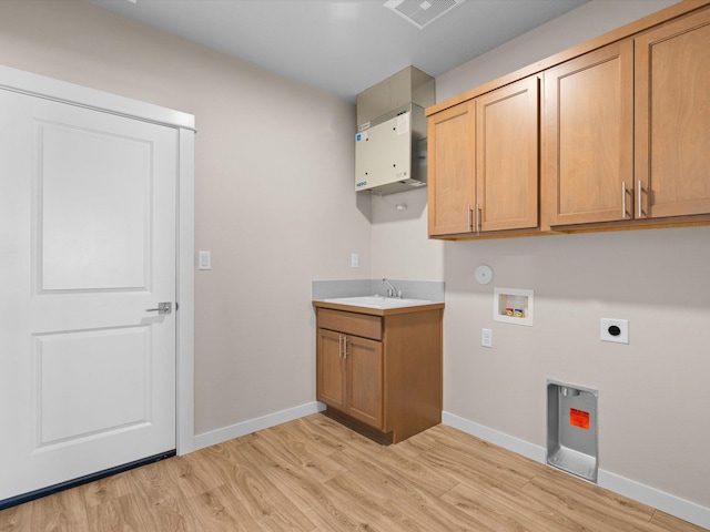 clothes washing area featuring cabinet space, baseboards, light wood-style flooring, hookup for a washing machine, and hookup for an electric dryer