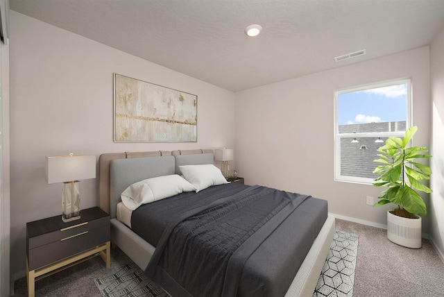 bedroom featuring carpet, visible vents, and baseboards