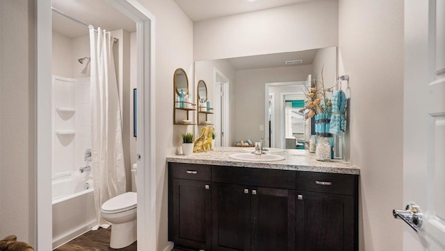 bathroom featuring toilet, wood finished floors, visible vents, vanity, and shower / bathtub combination with curtain