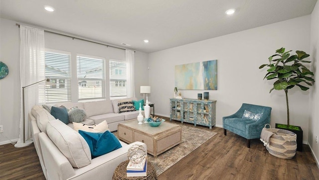 living area with baseboards, wood finished floors, and recessed lighting