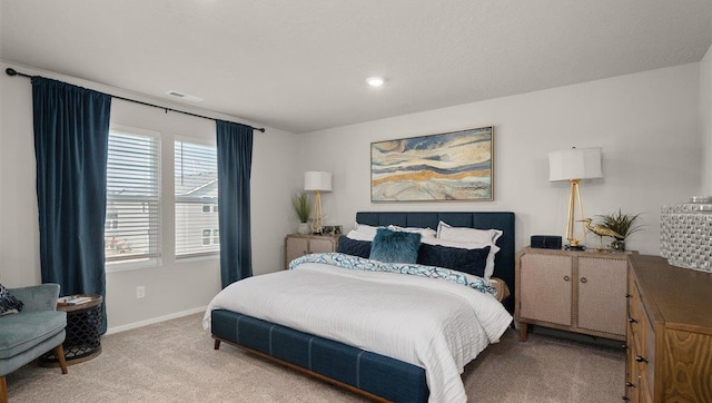 bedroom featuring light carpet, visible vents, and baseboards