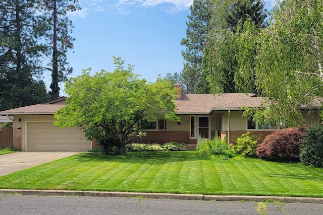 ranch-style home featuring an attached garage, brick siding, driveway, a chimney, and a front yard