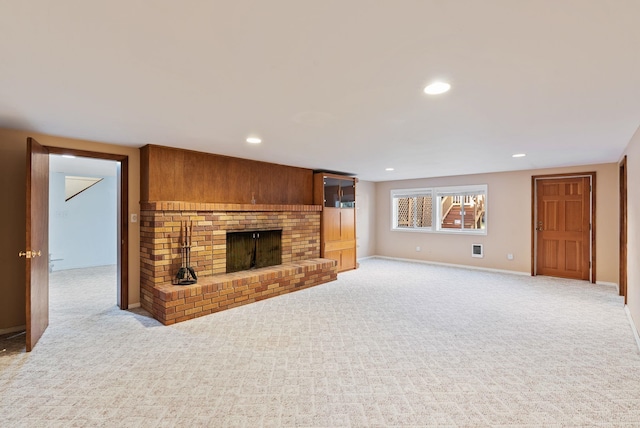 living room featuring light carpet, a brick fireplace, and recessed lighting