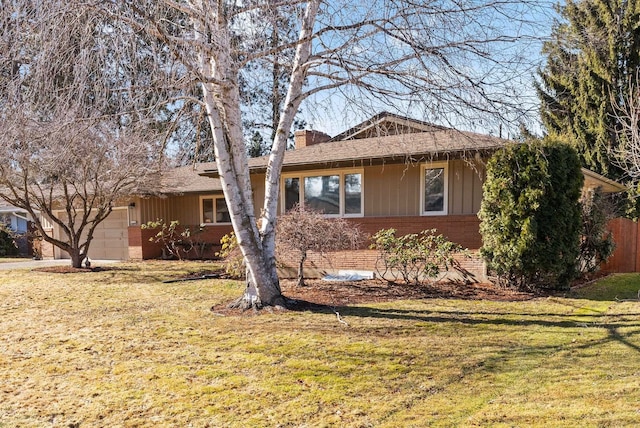 single story home featuring a garage, a chimney, a front lawn, and brick siding