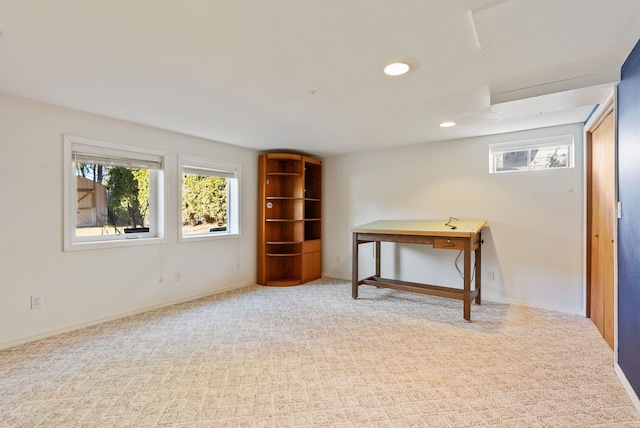 below grade area featuring recessed lighting, a healthy amount of sunlight, carpet flooring, and baseboards