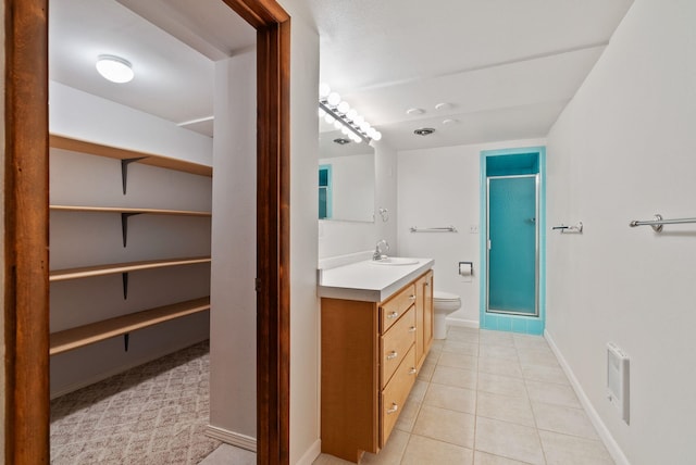 bathroom featuring tile patterned flooring, toilet, visible vents, vanity, and a shower stall