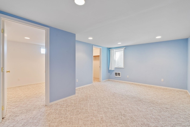 unfurnished room with recessed lighting, carpet, visible vents, and baseboards