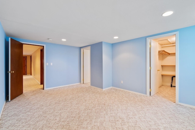 spare room with carpet floors, baseboards, and recessed lighting