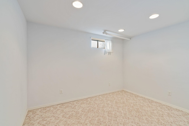 below grade area featuring baseboards, carpet flooring, and recessed lighting