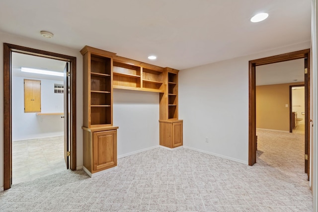 interior space featuring light carpet, baseboards, and recessed lighting