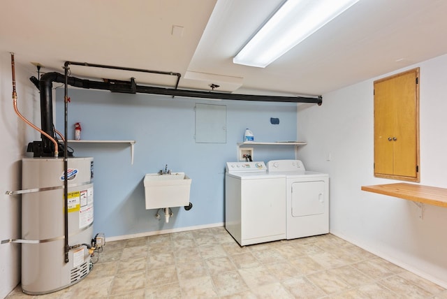 washroom with washer and dryer, secured water heater, baseboards, and laundry area