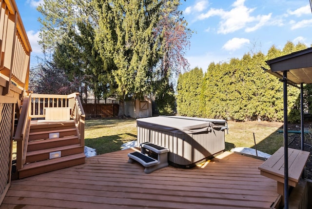 wooden terrace with a lawn, a fenced backyard, and a hot tub