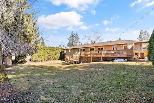 rear view of property with a lawn and a wooden deck