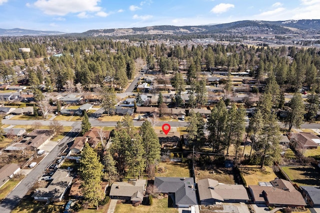 bird's eye view featuring a residential view, a mountain view, and a view of trees