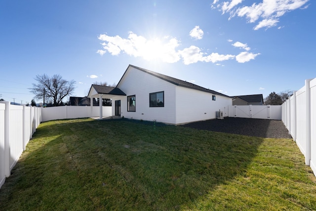 back of house with a yard, a fenced backyard, a gate, and central air condition unit