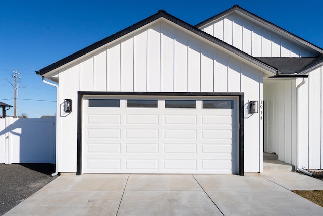 garage with driveway and fence