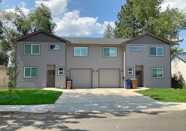 view of front facade featuring a garage, a front yard, driveway, and board and batten siding