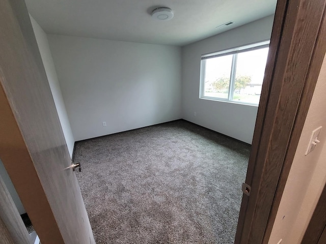 carpeted empty room with visible vents