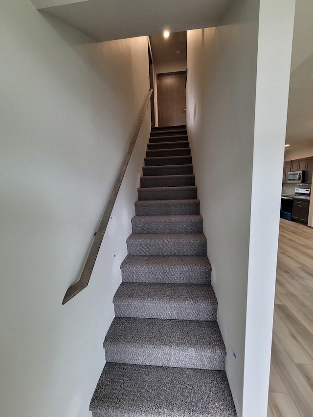 stairway with wood finished floors