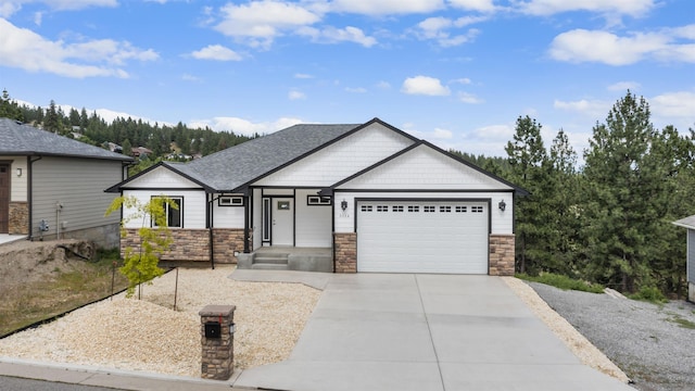 view of front of house featuring concrete driveway, stone siding, an attached garage, and a shingled roof