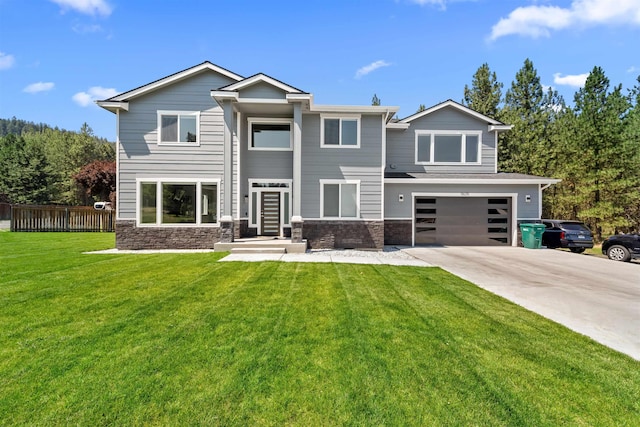 exterior space with concrete driveway, a lawn, fence, a garage, and stone siding