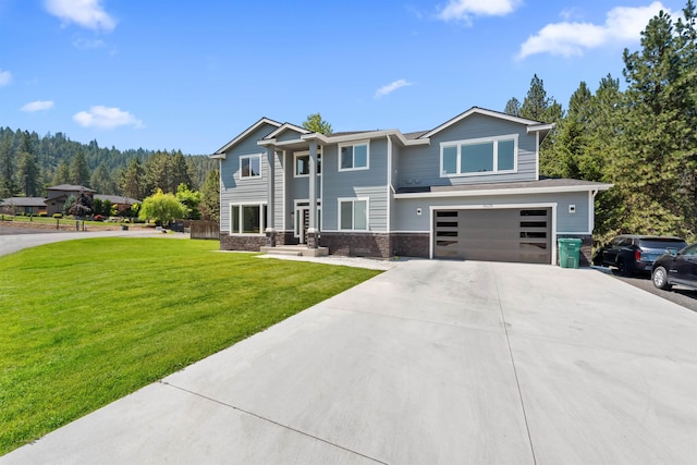 view of front of property with a front yard, stone siding, driveway, and an attached garage