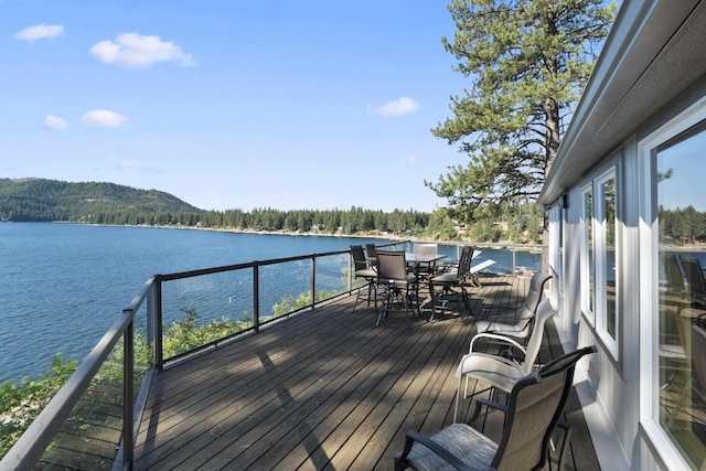 3917 N Deer Lake Rd, Loon Lake, WA 99148 - wooden terrace with a water view and outdoor dining area