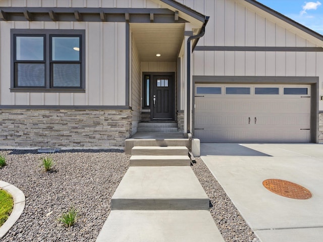 1624 S Moen St Unit 3/1Orchard, Spokane Valley, WA 99016 - entrance to property featuring board and batten siding, a garage, driveway, and stone siding