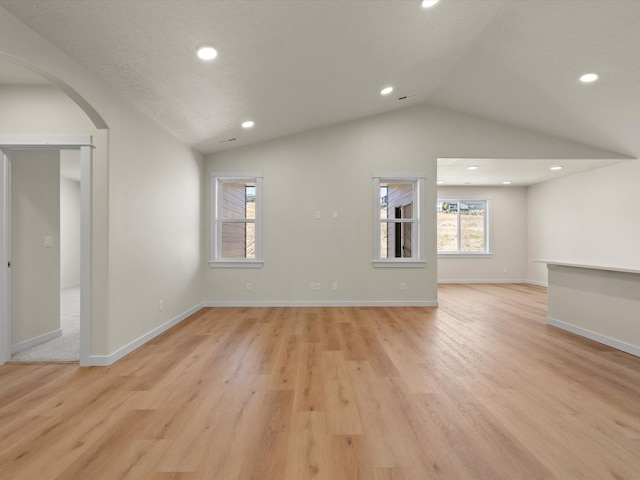 1624 S Moen St Unit 3/1Orchard, Spokane Valley, WA 99016 - unfurnished living room featuring vaulted ceiling, arched walkways, light wood-style flooring, and recessed lighting