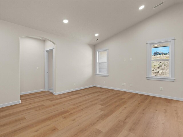 1624 S Moen St Unit 3/1Orchard, Spokane Valley, WA 99016 - empty room featuring lofted ceiling, recessed lighting, arched walkways, and light wood-style flooring