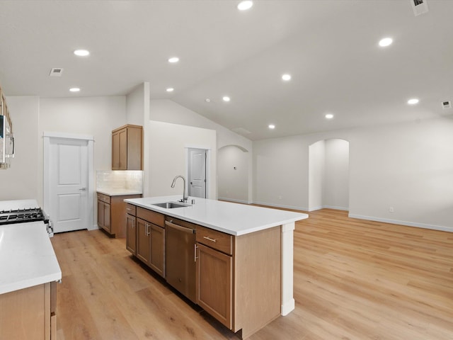 1624 S Moen St Unit 3/1Orchard, Spokane Valley, WA 99016 - kitchen featuring stainless steel appliances, arched walkways, an island with sink, light wood-style floors, and lofted ceiling