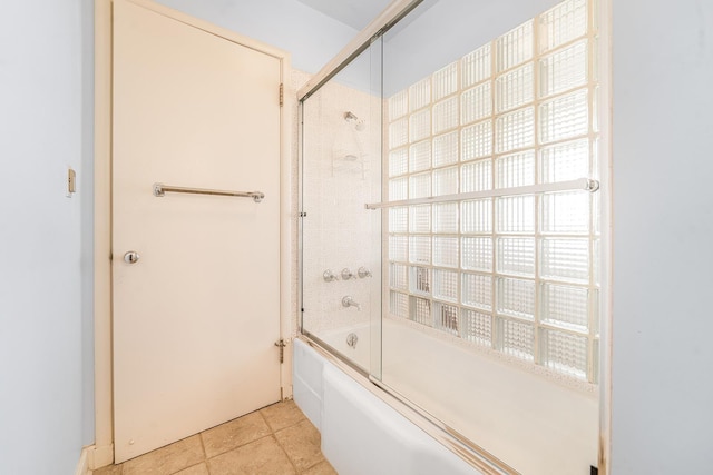 bathroom featuring shower / bath combination with glass door and tile patterned floors