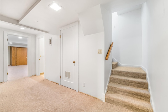 stairway with carpet floors, visible vents, and recessed lighting