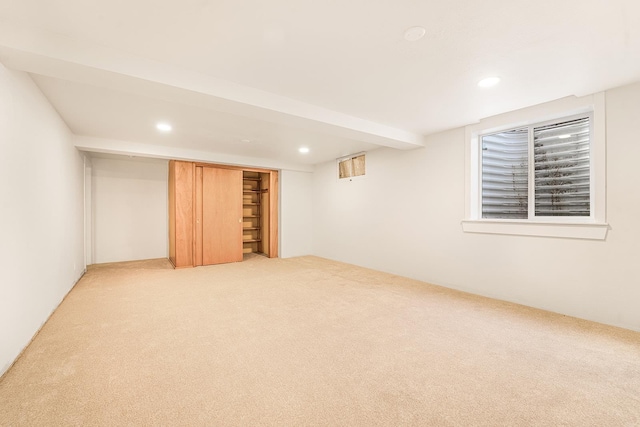 finished below grade area featuring recessed lighting and light colored carpet