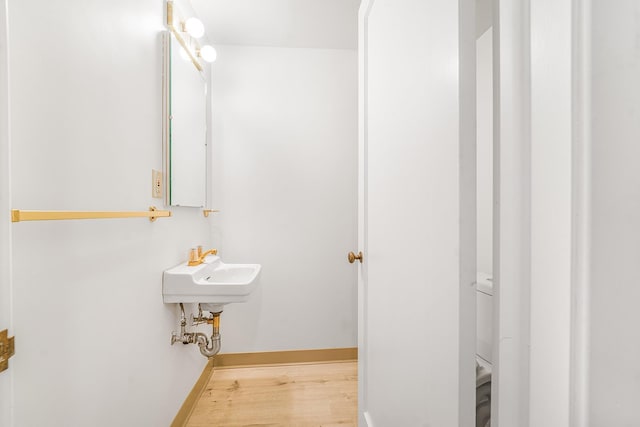 bathroom featuring baseboards and wood finished floors