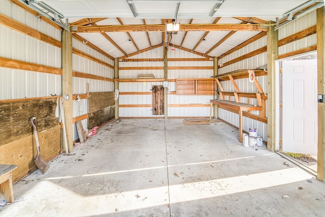 garage with a garage door opener and metal wall