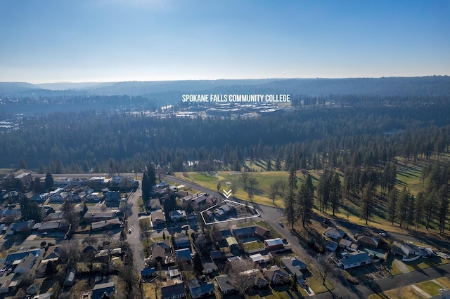 bird's eye view featuring a forest view and a residential view