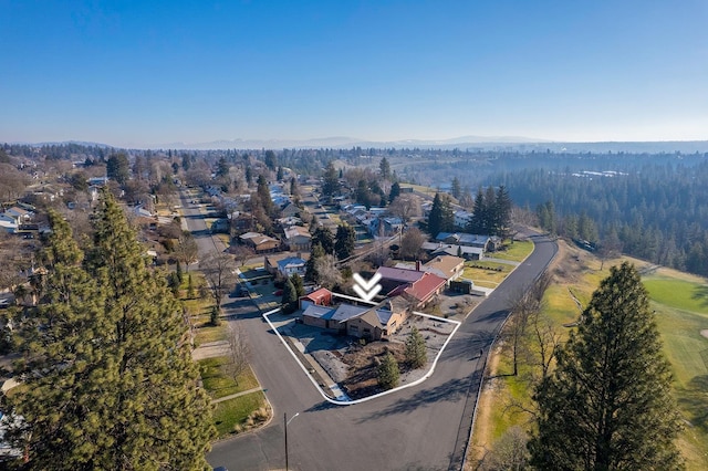 aerial view with a wooded view and a residential view