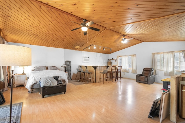 bedroom featuring wooden ceiling, wood finished floors, vaulted ceiling, a bar, and rail lighting